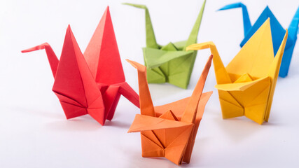 Colorful origami Crane birds in a dancing sequence
