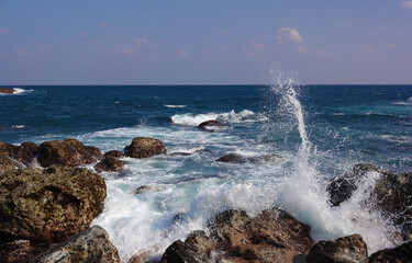 White waves rise after hitting the rocks in ocean - Powered by Adobe