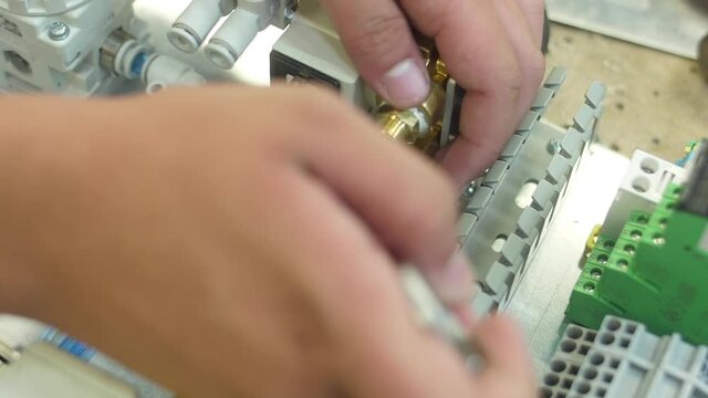 tighten brass nut with wrench in pneumatic automation system