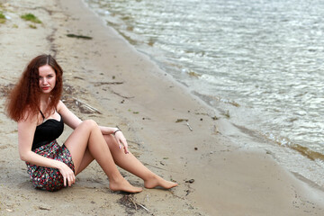 A girl at the river shore in spring