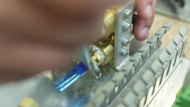 tighten brass nut with wrench in pneumatic automation system