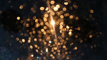 Rain drops on glass of car window with street bokeh at night in rainy season