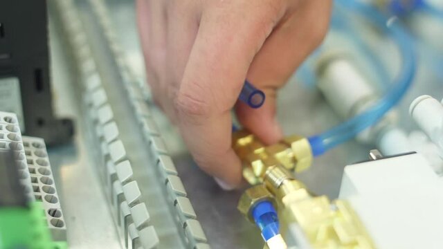 tighten brass nut with wrench in pneumatic automation system