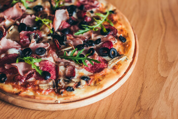 Delicious italian pizza served on wooden table on the pizza board