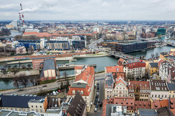 Fototapeta na wymiar Buildings over Oder river seen from tower of St Elisabeth Church in historic part of Wroclaw, Poland