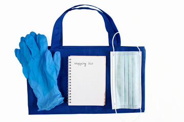 Rubber gloves, mask, bag, shopping list. A shopping motive during the coronavirus epidemic