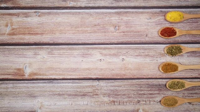 Wooden spoons with different spices move on right side - Stop motion 