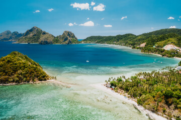 Aerial drone view of Las Cabanas sunny beach in El Nido, Palawan