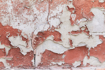 Old flaky cracked paint on gray wall, old paint background, selective focus