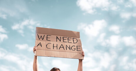 Group of activists with banners protesting over pollution and global warming. Male and female...