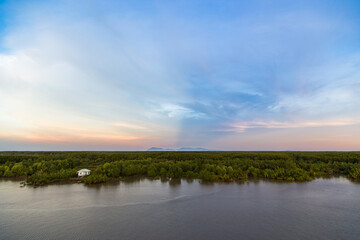 A beautiful landscape of a vietnamese forest with the Saigon River in the foreground with a spectacular sky.