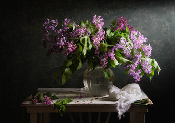 Still life with a bouquet of blooming lilacs                               