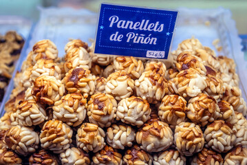 Shop window with pine nut panellets dessert in historic part of San Sebastian city, Spain