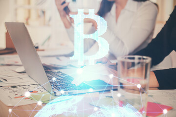 Double exposure of woman hands typing on computer and crypto market theme hologram drawing....