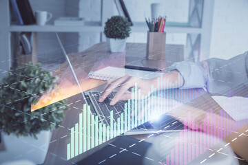 Double exposure of woman hands typing on computer and forex chart hologram drawing. Stock market invest concept.