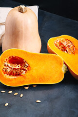 Nutmeg pumpkin dark background. Concept of fresh vegetables, grocery delivery, eco-friendly packaging. Photo for a grocery store kologologist.