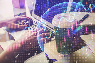 Double exposure of woman hands typing on computer and forex chart hologram drawing. Stock market invest concept.
