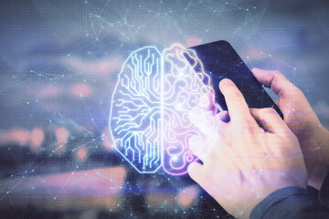 Double exposure of man's hand holding and using a digital device and brain hologram drawing. Data...