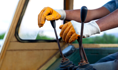 man using operator scoop with old and dirty gloves