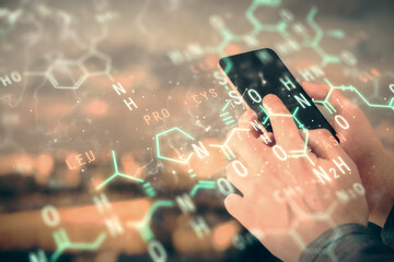 Double exposure of man's hands holding and using a phone and formulas drawing. Education concept.