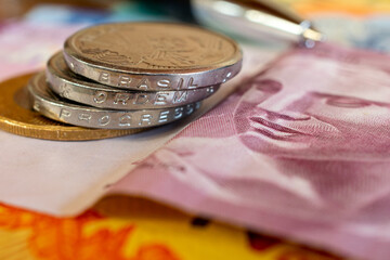 banknotes and coins of Brazilian money. Translation: order and progress Brazil.