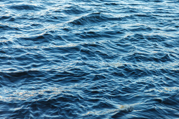 Waves on water surface. Wave pattern. View of surface fresh or sea water. Lapping sea waves. Background of sea or ocean wave. Water surface Wallpaper or background concept
