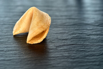 fortune cookie on a dark surface Copy space