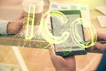 Double exposure of man's hands holding and using a phone and crypto currency blockchain theme...