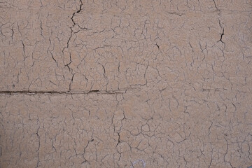 Texture. Cracks on clay wall.