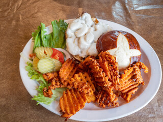Close up shot of delicious Mushroom Burger with fried Sweet potatoes and salad