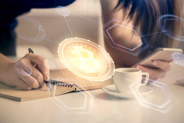 Double exposure of blockchain business sketch hologram and woman holding and using a mobile device.