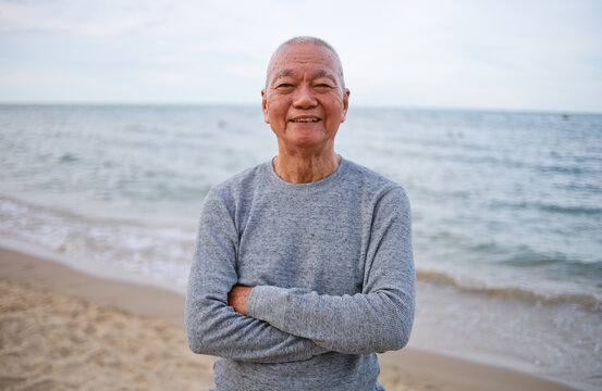 Asian Senior retirement man relax on the beach vintage color tone