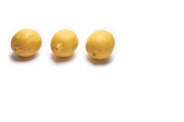 Three lemons on a white background