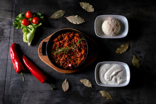 Guvec.Meat Saute Turkish Et sote, yogurt and rice with wooden table. turkish cuisine.Homemade delicious beef curry -Traditional cuisine.