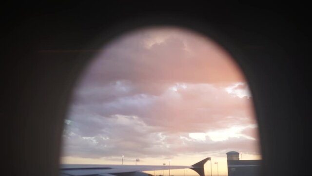 Purple cloudy sky at the airport laneway view from the plane window (slow motion 120fps)