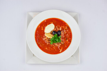 borscht on the table in a white plate and on a white background