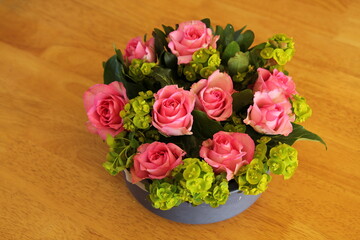 Floral arrangement featuring pink Roses in a bowl