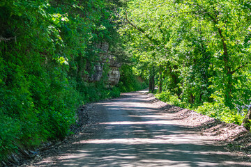 Naklejka premium Dirt road beside a cliff face.