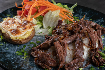 tandir kebab traditional turkish cuisine. Roasted lamb and rice pilaf with salad. 