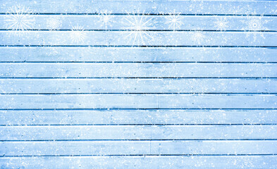 Snowflakes on a background of blue wooden texture. Copy Space	