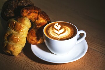 cup of coffee with croissant