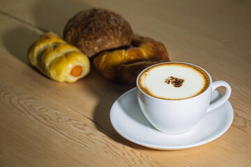cup of coffee with croissant