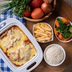 Parmegiana Steak also known as Filet Parmegiana. .Accompanied by vegetable salad, rice and french fries