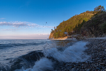 The wave rolls onto the shore of Lake Baikal