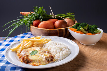 Parmegiana Steak also known as Filet Parmegiana. .Accompanied by vegetable salad, rice and french...