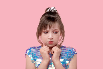Portrait of little frightened girl. The girl looks to the bottom and to the side