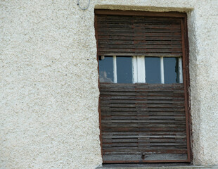 old window with broken shutters in the Ligurian countryside