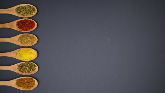 Eco friendly wooden spoons with spices moving on left side - Stop motion 