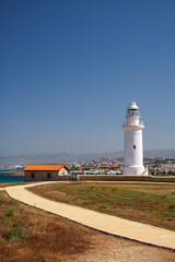 Fototapeta na wymiar Yellow road going to the Paphos lighthouse. Cyprus