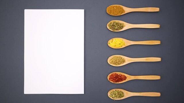 Eco friendly wooden spoons moving next to blank paper - Stop motion 